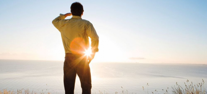 Mann schaut Sonnenuntergang